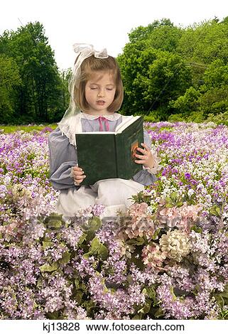 Girl Wearing Old Fashioned Blue Gingham Dress With Apron And Bow In Hair Reading Book In Field Of Flowers View Large Photo Image Stock Photo - Girl Wearing Old Fashioned Blue Gingham Dress With Apron And Bow In Hair Reading Book In Field Of Flowers . Fotosearch