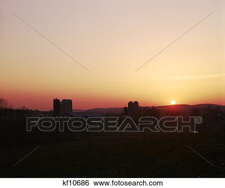 Golden Sunset Sunrise Over Farmland Scenic Landscape Silos Silhouetted Chester County Pennsylvania Mood View Large Photo Image Stock Photograph - Golden Sunset Sunrise Over Farmland Scenic Landscape Silos Silhouetted Chester County Pennsylvania Mood . Fotosearch