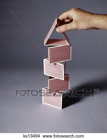 Picture - Hand Building House Tower Of Playing Cards Balance Stability Architecture Build House Of Cards Retro Vintage. Fotosearch