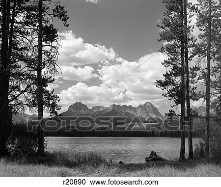 Stock Image - Little Redfish Lake In Idaho With Sawtooth Mountains In Background Viewed Between Clearing In Trees . Fotosearch