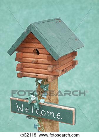 Log Cabin Style Birdhouse With Green Roof And Welcome Sign View Large Photo Image Stock Photo - Log Cabin Style Birdhouse With Green Roof And Welcome Sign . Fotosearch