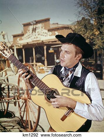 Stock Image - Man Guitar Cowboy Strumming Western Country Acoustic 1970 1970S Retro. Fotosearch