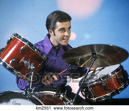 Stock Image - Man Playing Drums Drum Sticks Drum Set Retro 1970 1970S Percussian. Fotosearch