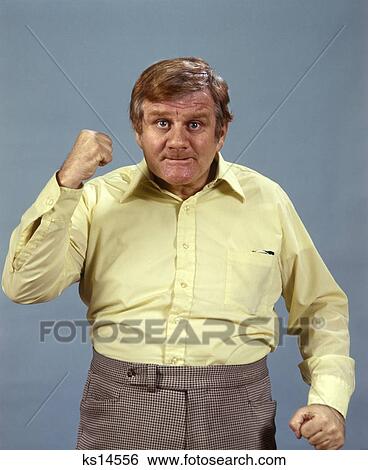 Man Raising Fist Angry Threatening 1970 1970S Retro View Large Photo Image Stock Photograph - Man Raising Fist Angry Threatening 1970 1970S Retro. Fotosearch
