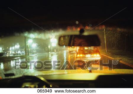 Man Reflected In Rearview Mirror Driving Car Rainy Chicago Street Night View Large Photo Image Stock Photo - Man Reflected In Rearview Mirror Driving Car Rainy Chicago Street Night. Fotosearch