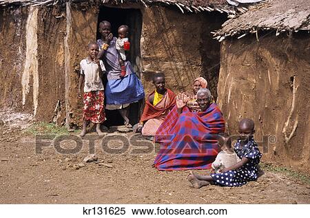 Stock Photography - Masai Women And Children Outside Dung Covered Huts Masai Mara Kenya. Fotosearch