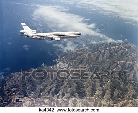 Mcdonnell Douglas Dc 10 Series Airplane Flying Over Mountainous Terrain View Large Photo Image Stock Image - Mcdonnell Douglas Dc 10 Series Airplane Flying Over Mountainous Terrain. Fotosearch