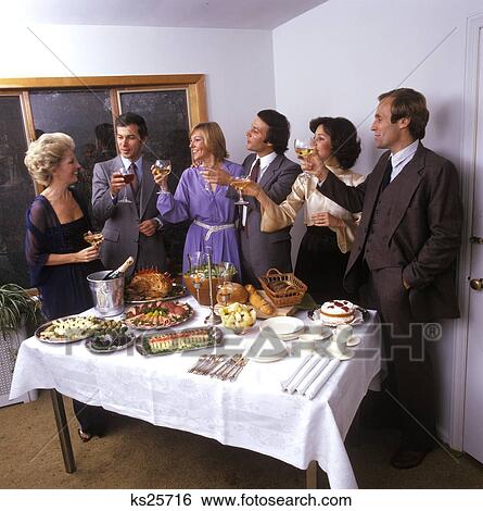 Middle Aged Guests House Party Toasting Food Neatly Layed Out Table 1970 1970S Retro View Large Photo Image Stock Photograph - Middle Aged Guests House Party Toasting Food Neatly Layed Out Table 1970 1970S Retro . Fotosearch
