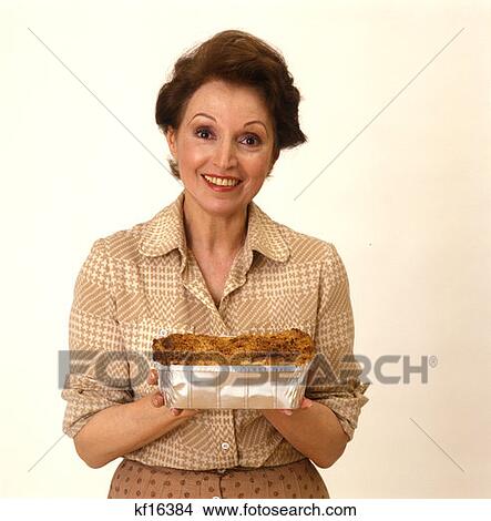 Middle Aged Woman Holding Baked Goods Coffee Cake Loaf Wearing Earth Tones 1970 1970S Retro View Large Photo Image Picture - Middle Aged Woman Holding Baked Goods Coffee Cake Loaf Wearing Earth Tones 1970 1970S Retro . Fotosearch