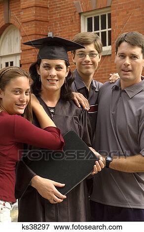 Stock Photo - Mother Graduate Poses With Family At Graduation. Fotosearch