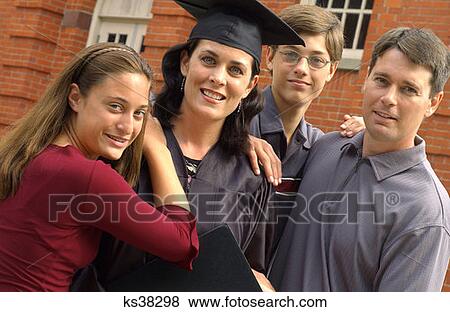 Mother Graduate Poses With Family At Graduation View Large Photo Image Stock Photo - Mother Graduate Poses With Family At Graduation. Fotosearch