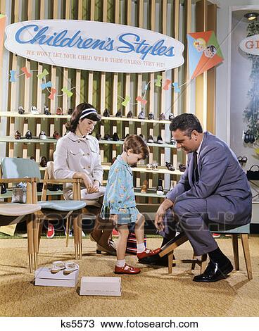Mother Watching Salesman Fit Shoes On Daughter In Shoe Section Of Department Store View Large Photo Image Stock Image - Mother Watching Salesman Fit Shoes On Daughter In Shoe Section Of Department Store . Fotosearch