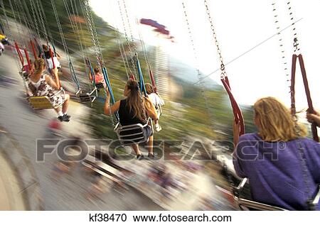 Stock Image - People On Swing Ride At Amusement Park Knoebels Park Elysburg Pa . Fotosearch