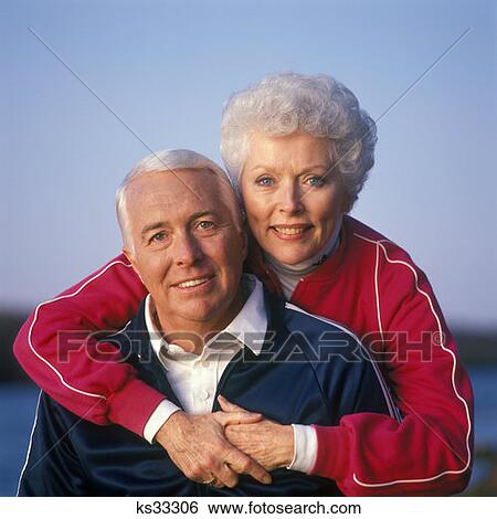 Portrait Of Couple In Jogging Suits Woman Standing With Her Arms Around The Man View Large Photo Image Stock Photograph - Portrait Of Couple In Jogging Suits Woman Standing With Her Arms Around The Man . Fotosearch