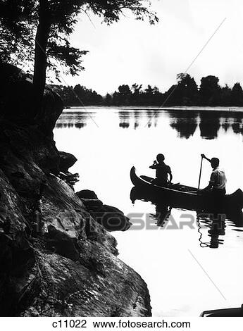 Stock Image - Posterization Of Couple Canoeing In Lake Surrounded By Rocks & Trees . Fotosearch