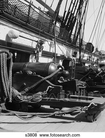 Stock Photo - Row Of Back Ends Of Cannons From Interior Of Battleship . Fotosearch