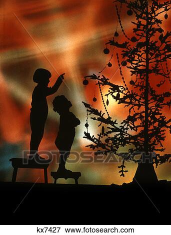 Silhouette Of 2 Children On Stools Look To Pointing At Christmas Tree Colorful Lights Background Retro Vintage View Large Photo Image Stock Photo - Silhouette Of 2 Children On Stools Look To Pointing At Christmas Tree Colorful Lights Background Retro Vintage. Fotosearch