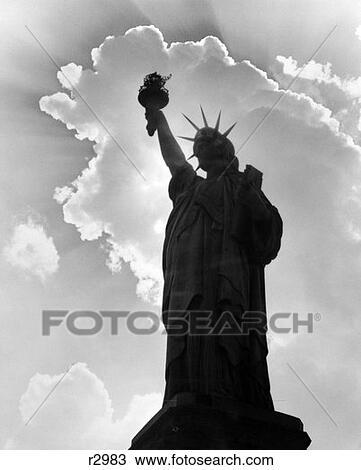 Stock Image - Silhouette Of Statue Of Liberty With Clouds Behind Her . Fotosearch
