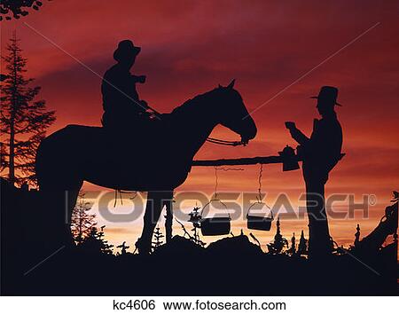 Silhouettes Of Cowboy On Horse And Cowboy Standing Drinking Holding Kettle Camp Set Up Cooking Sunset In Background View Large Photo Image Stock Photograph - Silhouettes Of Cowboy On Horse And Cowboy Standing Drinking Holding Kettle Camp Set Up Cooking Sunset In Background. Fotosearch