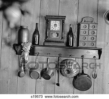Small Shelf Holding Antique Clock Spice Cabinet Bottles Etc. With Rack For Hanging Pots & Pans View Large Photo Image Stock Image - Small Shelf Holding Antique Clock Spice Cabinet Bottles Etc. With Rack For Hanging Pots & Pans . Fotosearch