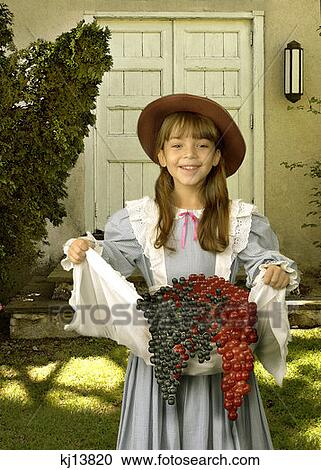 Smiling Girl Wearing Old Fashioned Blue Gingham Dress And Hat Holding Bunches Of Grapes In Apron View Large Photo Image Stock Image - Smiling Girl Wearing Old Fashioned Blue Gingham Dress And Hat Holding Bunches Of Grapes In Apron . Fotosearch