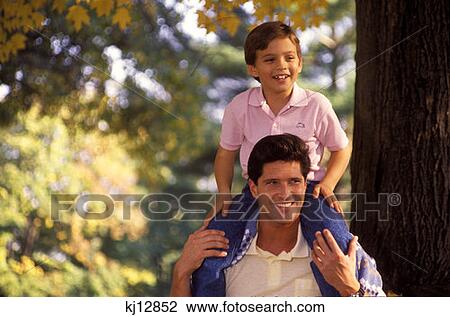 Son Sitting On Shoulders Of Father Outdoors In The Fall View Large Photo Image Stock Image - Son Sitting On Shoulders Of Father Outdoors In The Fall . Fotosearch