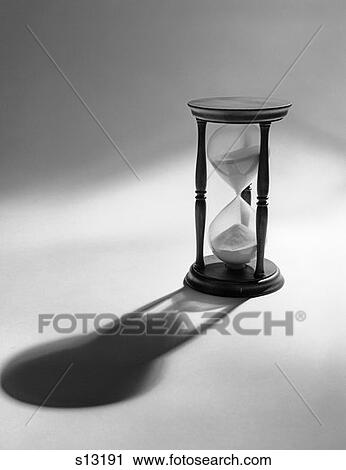 Still Life Of Hourglass With Sand Halfway Down Casting Shadow View Large Photo Image Stock Image - Still Life Of Hourglass With Sand Halfway Down Casting Shadow . Fotosearch