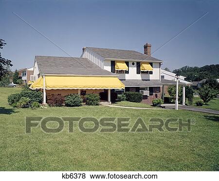 Suburban Home House Residential Neighborhood White With Black Shutters Yellow Awnings Front Lawn View Large Photo Image Stock Photo - Suburban Home House Residential Neighborhood White With Black Shutters Yellow Awnings Front Lawn. Fotosearch