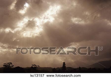 Sun Rays Streaming Through Clouds New Zealand View Large Photo Image Stock Photo - Sun Rays Streaming Through Clouds New Zealand . Fotosearch