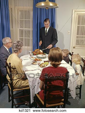 Three Generation Family Sitting At Table Father Carving Roast Chicken Indoor Man Woman Boy Girl View Large Photo Image Stock Image - Three Generation Family Sitting At Table Father Carving Roast Chicken Indoor Man Woman Boy Girl . Fotosearch
