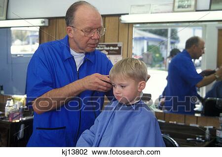 Stock Image - Three Year Old Boy Getting Haircut At Barber Shop . Fotosearch
