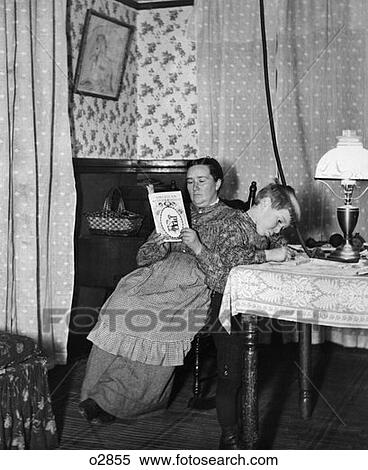 Turn Of The Century Boy Playing At Table In Sitting Room With Mother In Chair Behind Him Reading View Large Photo Image Stock Photography - Turn Of The Century Boy Playing At Table In Sitting Room With Mother In Chair Behind Him Reading . Fotosearch
