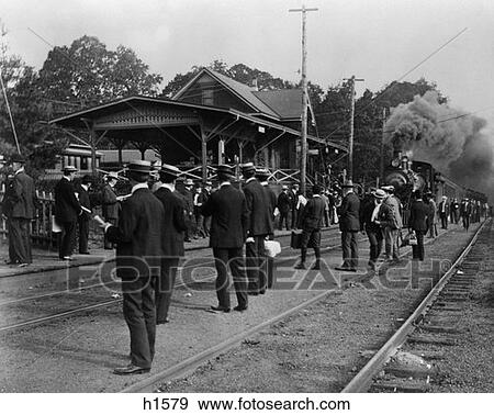 Turn Of The Century Crowd Standing At Train Station & Along Tracks Waiting For Train Coming In View Large Photo Image Stock Photo - Turn Of The Century Crowd Standing At Train Station & Along Tracks Waiting For Train Coming In . Fotosearch