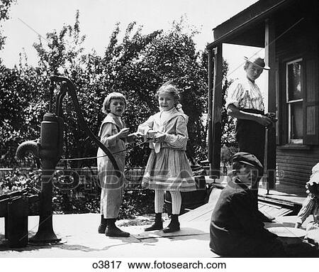 Turn Of The Century Group Of Children Standing On Front Porch Two Girls Playing By Water Pump View Large Photo Image Stock Photo - Turn Of The Century Group Of Children Standing On Front Porch Two Girls Playing By Water Pump . Fotosearch