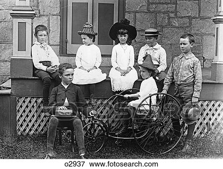 Turn Of The Century Group Of Seven Children Sitting On & Around Porch One Girl On Old Fashioned Tricycle View Large Photo Image Stock Photo - Turn Of The Century Group Of Seven Children Sitting On & Around Porch One Girl On Old Fashioned Tricycle . Fotosearch