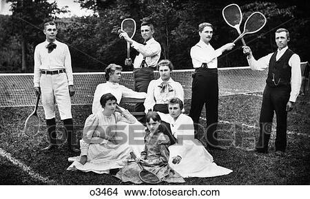 Turn Of The Century Group Portrait Of Men & Women & One Child In Front Of Net On Grass Tennis Court Holding Racquets View Large Photo Image Picture - Turn Of The Century Group Portrait Of Men & Women & One Child In Front Of Net On Grass Tennis Court Holding Racquets . Fotosearch