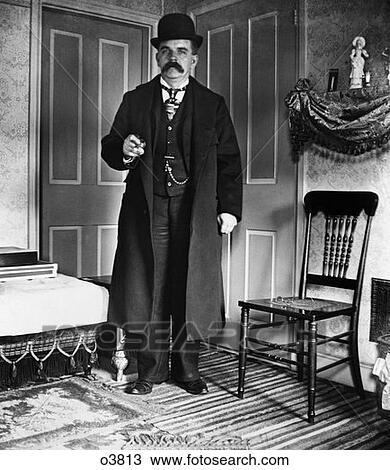 Turn Of The Century Man With Bushy Mustache Wearing Bowler Three-Piece Suit With Pocket Watch & Long Coat View Large Photo Image Stock Image - Turn Of The Century Man With Bushy Mustache Wearing Bowler Three-Piece Suit With Pocket Watch & Long Coat . Fotosearch