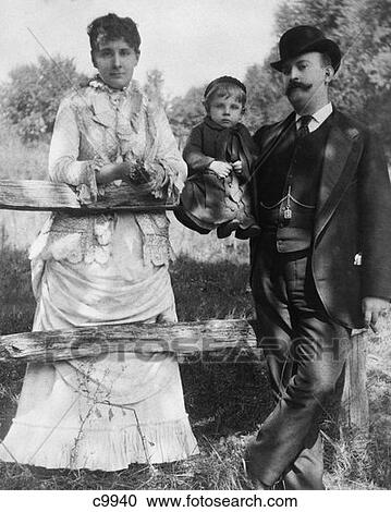 Turn Of The Century Man & Woman Standing At Post & Rail Fence With Child Sitting On Rail View Large Photo Image Stock Image - Turn Of The Century Man & Woman Standing At Post & Rail Fence With Child Sitting On Rail . Fotosearch