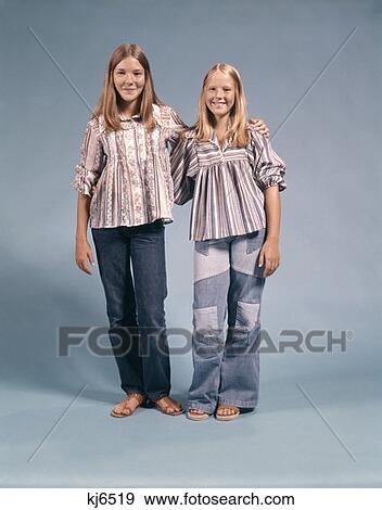 Two Teenage Girls In 1970 1970S Clothing Standing Arms Around Each Other Smiling View Large Photo Image Stock Photo - Two Teenage Girls In 1970 1970S Clothing Standing Arms Around Each Other Smiling. Fotosearch
