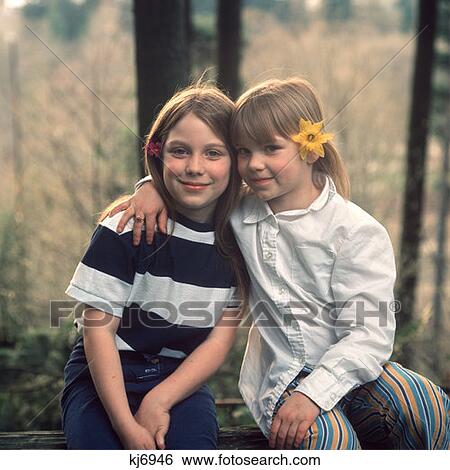 Two Young Girls With Flowers In Their Hair Sitting Outside Retro 1970 1970S View Large Photo Image Stock Photograph - Two Young Girls With Flowers In Their Hair Sitting Outside Retro 1970 1970S. Fotosearch