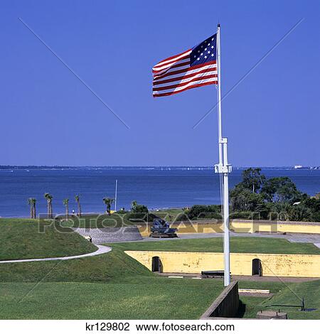 Stock Image - Us Flag Flying Over Fort Moultrie Near Mount Pleasant South Carolina . Fotosearch