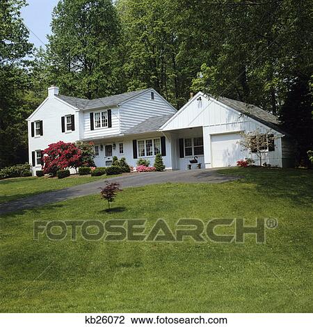 Stock Image - White Suburban House Black Shutters. Fotosearch