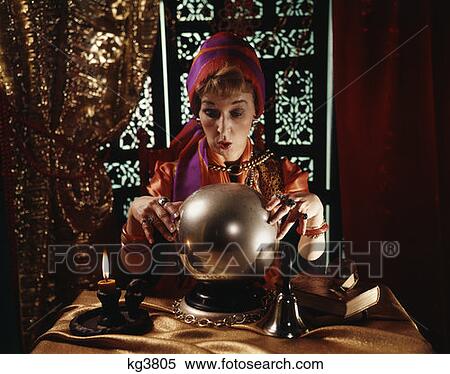 Woman Dressed As Fortune Teller Looking Into Crystal Ball Lace Curtains And Carved Shutter Background Indoor View Large Photo Image Stock Photography - Woman Dressed As Fortune Teller Looking Into Crystal Ball Lace Curtains And Carved Shutter Background Indoor . Fotosearch