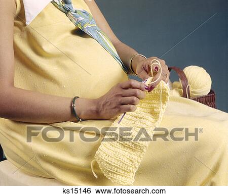 Stock Photograph - Woman Pregnant Knitting Needles 1970S 1977 Yarn. Fotosearch