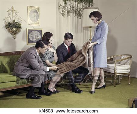 Woman Showing Fur Coat To Two Men And A Woman In Living Room Indoor Lifestyle Gift View Large Photo Image Stock Photo - Woman Showing Fur Coat To Two Men And A Woman In Living Room Indoor Lifestyle Gift . Fotosearch