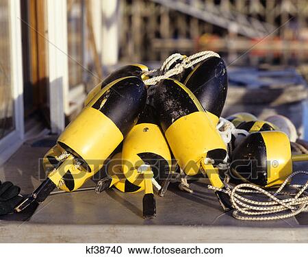 Stock Image - Yellow And Black Lobster Buoys Maine . Fotosearch