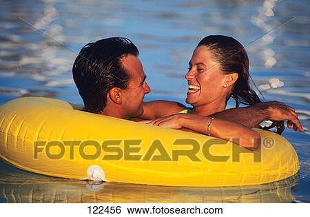 Young Couple In Innertube In The Pool View Large Photo Image Stock Photograph - Young Couple In Innertube In The Pool. Fotosearch