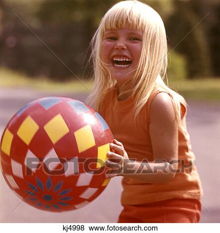 Stock Photo - Young Girl Playing Big Red Diamond Ball Blond Blonde Smiling Laughing . Fotosearch