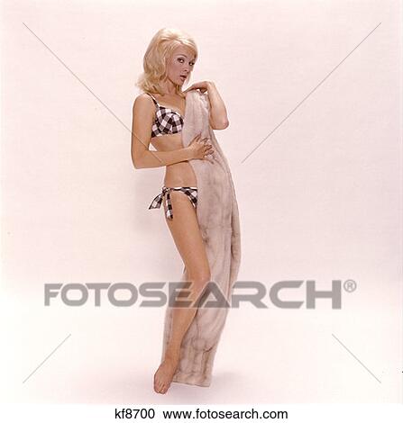 Young Woman In Polka Dot Bikini Holding Long Fur Stole To Herself Lifestyle 1970S View Large Photo Image Stock Image - Young Woman In Polka Dot Bikini Holding Long Fur Stole To Herself Lifestyle 1970S . Fotosearch