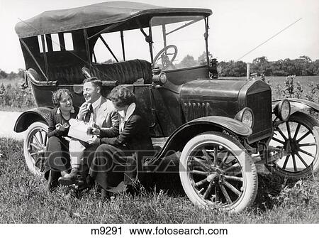 1910S Group Of Two Women & One Man Sitting On Running Board Of Model T Ford Talking & Laughing View Large Photo Image Stock Image - 1910S Group Of Two Women & One Man Sitting On Running Board Of Model T Ford Talking & Laughing . Fotosearch